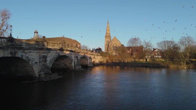 Pigeons in Flight Over English Bridge and River Severn with Church Spire, Shrewsbury
