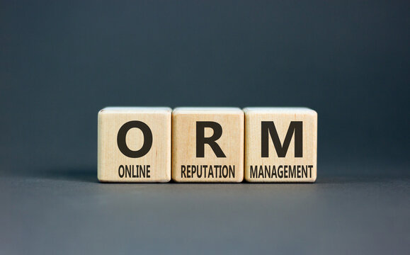 ORM online reputation management symbol. Concept words ORM online reputation management on beautiful wooden blocks. Beautiful grey background. Business ORM concept. Copy space.