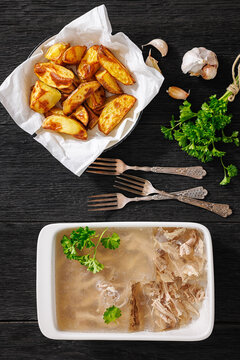 Traditional pork jelly dish with baked potatoes