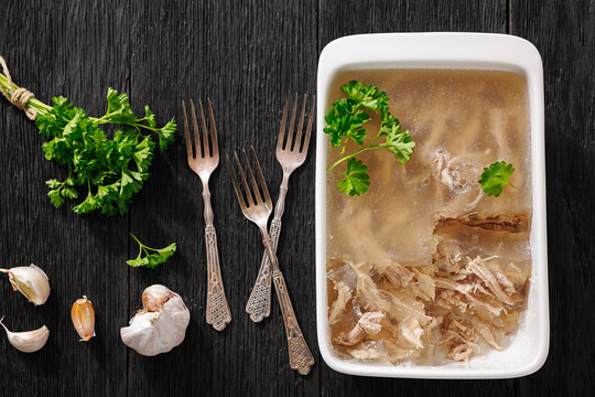 Cold meat aspic dish on dark wood table