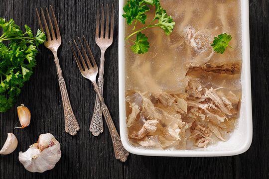 Cold meat aspic dish on dark wood table