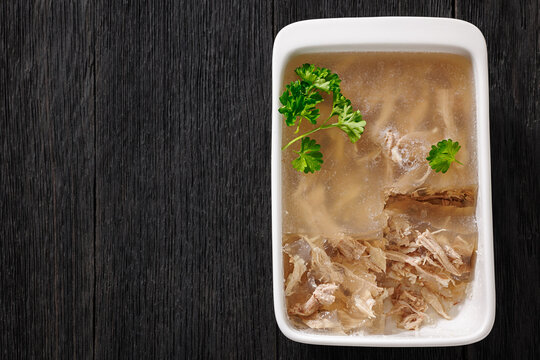 Cold meat aspic dish on dark wood table