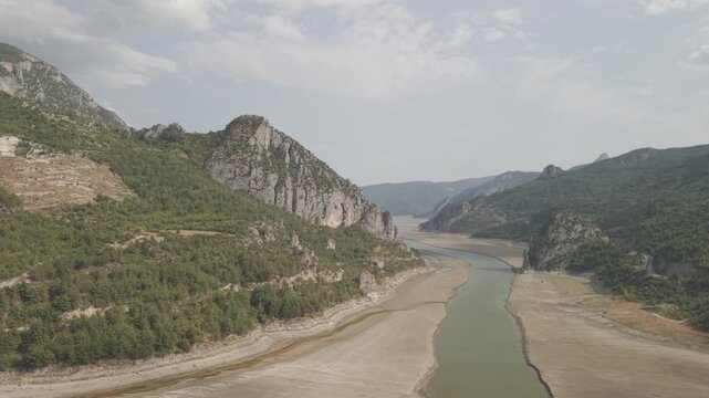 4K 10-bit cinematic drone strafe shot flying laterally past the giant rocky walls of Sahinkaya Canyon on a sunny day in Turkey
