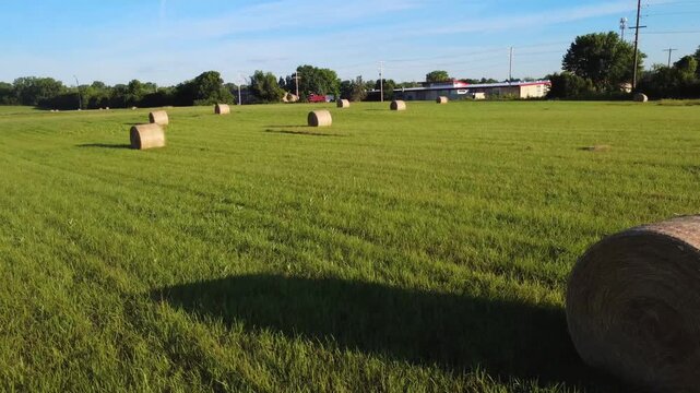 Drone shot of grass bales in a wide, green field in Westerville, Ohio