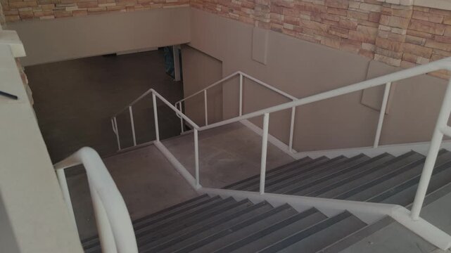 Slow rotational glide reveals an outdoor staircase with white railings leading down.