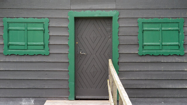 Grey Wooden Door with Green Shutters