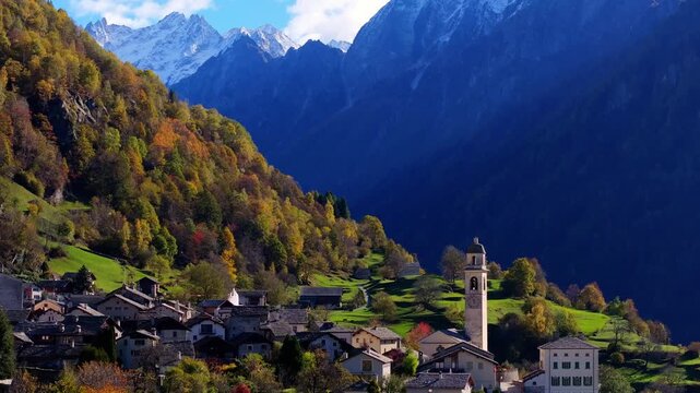 Aerial view of Soglio village with its historic stone houses and church tower nestled in the mountains of Bregaglia, Grisons, Switzerland.