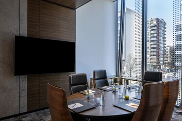 Fotobehang Hotel chique Executive round conference table in modern meeting room with city view  © rilueda