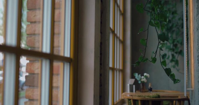 View of large wooden windows in a cozy cafe with a brick wall
