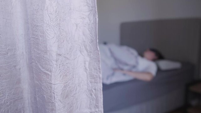 Young woman in bed struggling to fall asleep, experiencing insomnia and restlessness at night. She lies awake under the blanket, unable to relax or fall asleep. Sleep disorder, insomnia