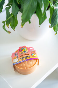 Prague, Czech Republic - June 17, 2026: Rainbow Mystery Bun squishy toy in original retail packaging displayed on a white table