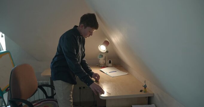 Kid Boy Wipe Desk with Wet Sponge Cleaning Table in Room. 4K 10-bit