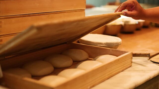Chef Opening Wooden Proofing Box Filled with Fresh Pizza Dough Balls