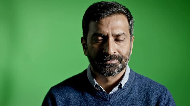Man's face expressing emotions with subtle shifts in lighting and camera angle during a green screen portrait session