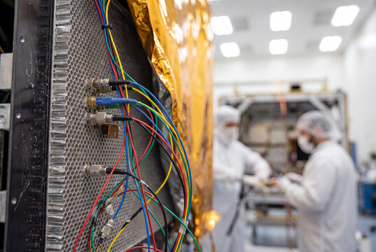 Satellite wiring inspection during spacecraft integration inside cleanroom facility