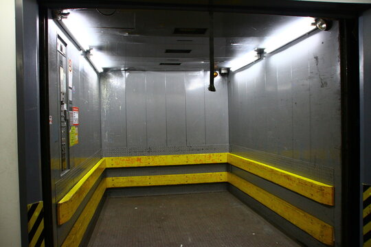 An empty freight elevator with open doors.