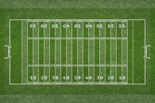 Empty striped american football field texture. Green grass texture - well-groomed turf and tactics lines.