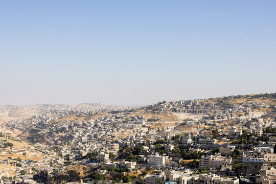 Sprawling residential buildings and traditional stone houses built across the rolling hills of Jerusalem