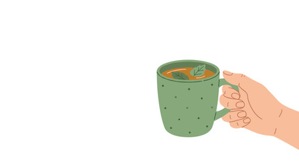 Obraz premium Hand holding a green polka dot mug filled with herbal tea and fresh mint leaves
