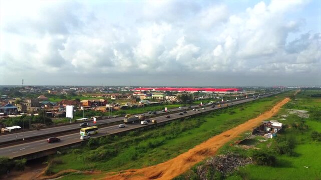 Aerial view of Warewa Opic Estate Drive with traffic on the highway and green landscape in Iseri, Ogun State, Nigeria.