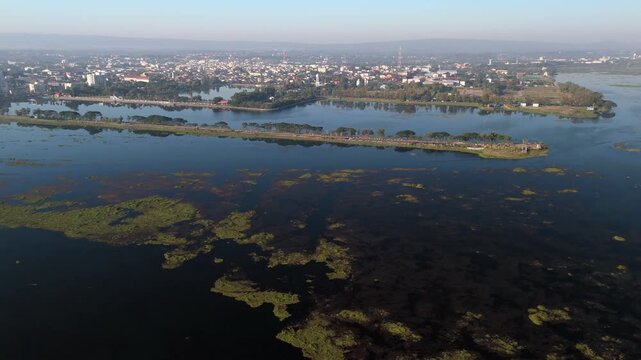 Aerial drone view of Nong Han Lake, the largest natural lake in northeast Thailand, sitting right on the edge of Sakon Nakhon town