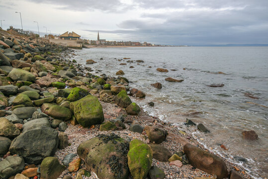 East end of Portobello beach in Edinburgh, overcast autumn day, Joppa parish church tower visible at distance