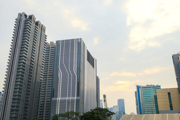 Fototapeta premium Two Massive Highrise Residential Buildings Tower Into The Sky Featuring Numerous Apartment Balconies