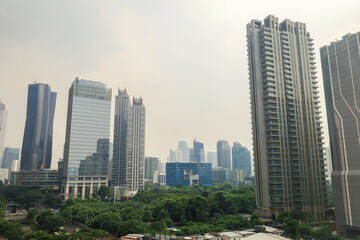 Obraz premium Dense Metropolitan Skyline Features Towering Glass Skyscrapers And Contemporary Highrise Buildings