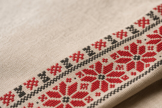 Close-up of traditional Ukrainian embroidery with red and black cross-stitch.