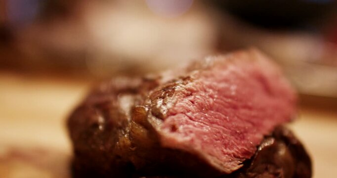 Extreme close up shot of sliced medium rare beef steak showing pink interior texture