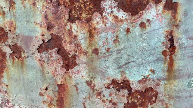 Background of paint flaking and rust panning shot movement wallpaper and abstract colour and surface.