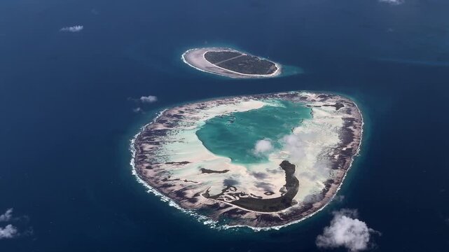 4k aerial landscape video footage flying along Saint-Joseph-Atoll,  with D'Arros Island behind as part of the Amirante Islands group in the territory of Seychelles, located in Indian Ocean 