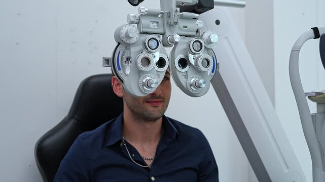 Man receiving a comprehensive eye exam using a phoropter in a professional optometry clinic