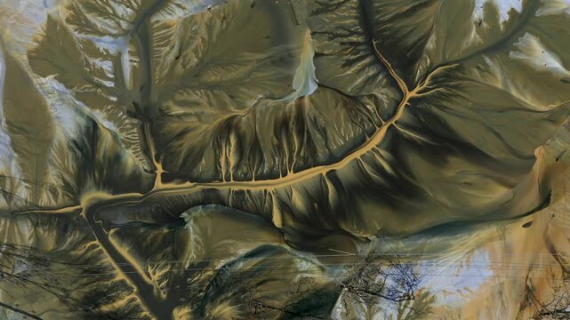     Aerial view of surreal natural patterns of gold cyanide leaching flowing into decanting lake by drone