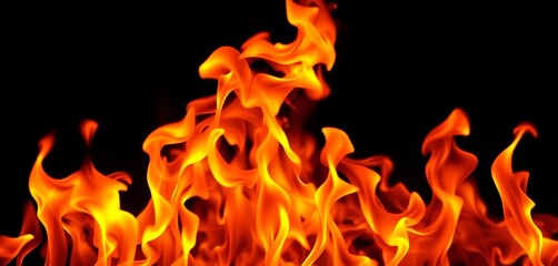 Fototapeta premium Intense orange and yellow flames dancing against a black background, warning, abstract