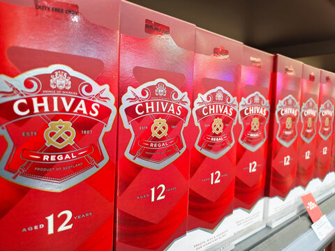 Moscow, Russia - June 22, 2026: Chivas Regal 12 Years Old Scotch whisky boxes lined up on a shelf in a retail store, showcasing the iconic red packaging and logo