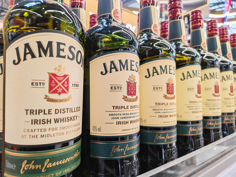 Moscow, Russia - June 22, 2026: Jameson Irish whiskey bottles lined up on a shelf, featuring distinct labels and green glass design, showcasing brand heritage and quality
