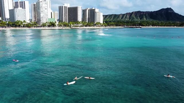 Surfing in waikiki beach with diamond head view
