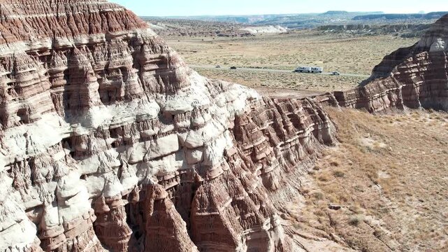 Aerial View of Layered Rock Formations in the Arizona Badlands, Scenic Desert Landscape Under Blue Sky