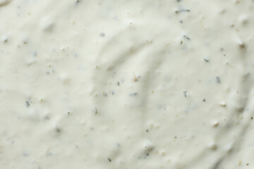 Close-up texture of creamy tartar sauce with herbs top view © Zarina Lukash