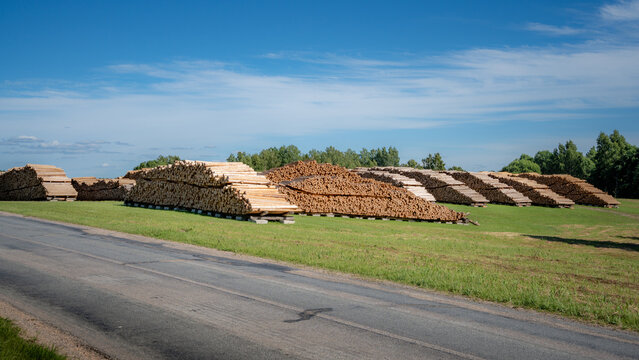 Timber Log Yard Beside Rural Road for Forestry, Wood Processing and Lumber Supply Industry