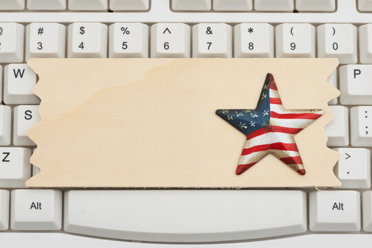 Wood sign with American flag star on a white computer keyboard for civic technology