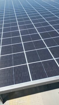 Factory hall with solar panels on roof, renewable energy for industrial production vertical 4k Vertical