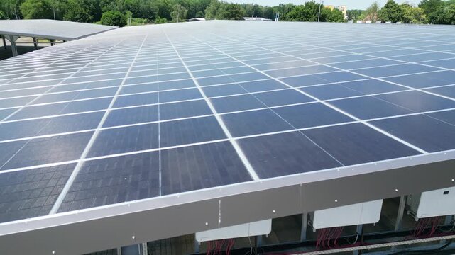 Factory hall with solar panels on roof, renewable energy for industrial production