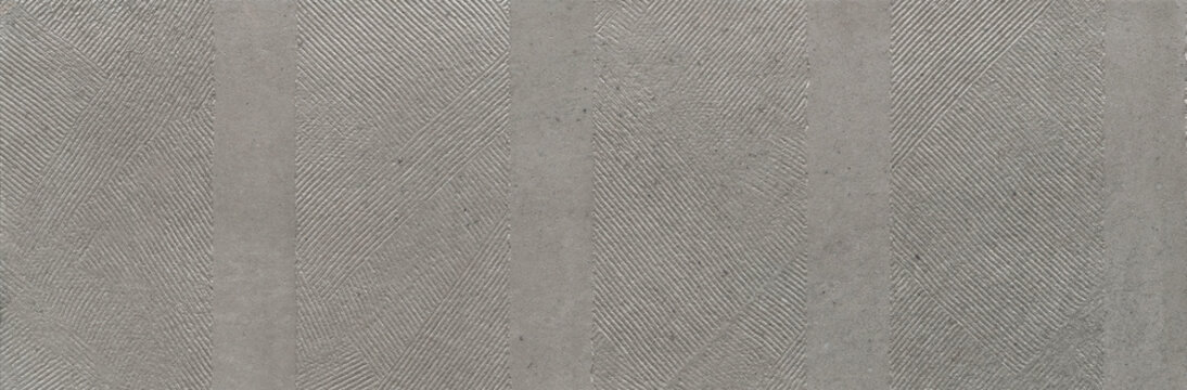 Minimal gray concrete texture with geometric striped relief pattern. Modern architectural surface background featuring subtle linear details and industrial style.