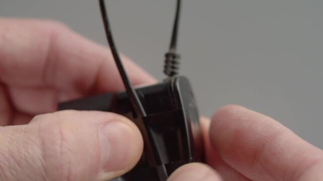 Securing cable with tape. Precise taping to strengthen cable entry and ensure safety. Hands carefully tape cable entry to improve reliability and safety of connection