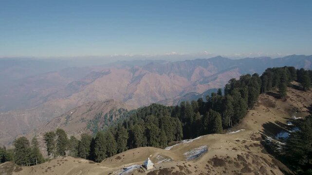 Aerial view of forested mountain slopes and distant hazy peaks in Chakrata, Dehradun, Uttarakhand