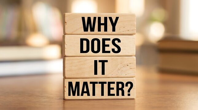 Wooden blocks stacked vertically displaying why does it matter on a desk with question importance relevance philosophy curiosity