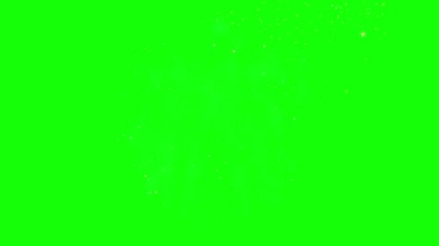 Fireworks explode in a vibrant display of golden and teal light against a solid green background.