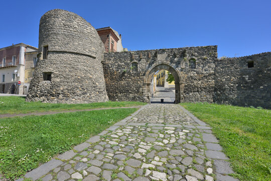 Melfi ancient stone city walls with gate Porta Venosina and defense tower standing tall under a clear blue sky. Basilicata, Italy